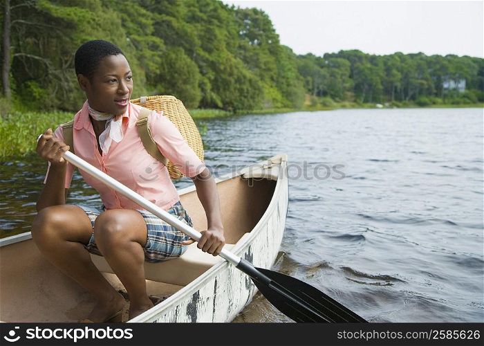 Mid adult woman canoeing