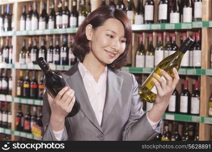 Mid Adult Woman Choosing Wine in a Liquor Store