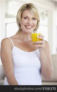 Mid Adult Woman Drinking Orange Juice
