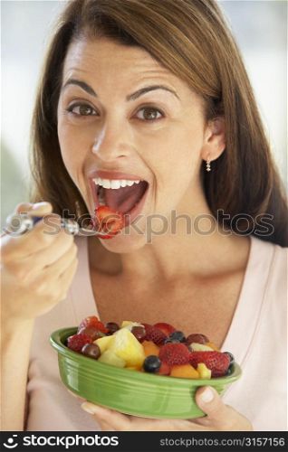 Mid Adult Woman Eating A Fresh Fruit Salad