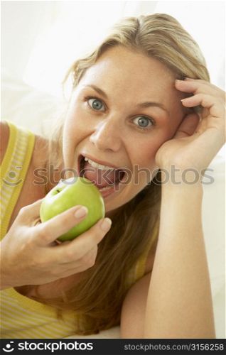 Mid Adult Woman Eating A Healthy Apple