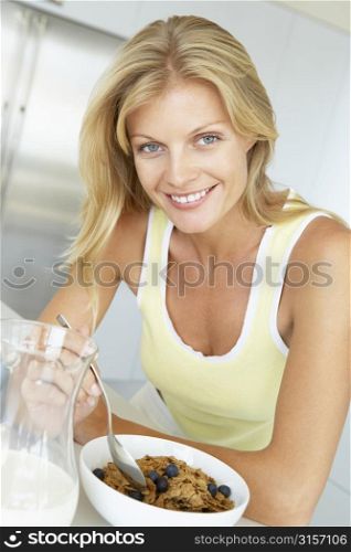 Mid Adult Woman Eating Cereal With Fruit