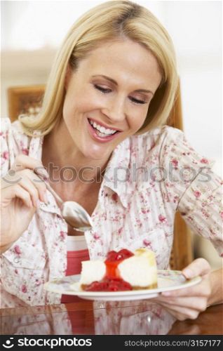 Mid Adult Woman Eating Cheesecake