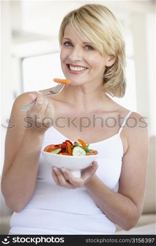 Mid Adult Woman Eating Salad