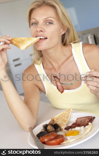 Mid Adult Woman Eating Unhealthy Fried Breakfast