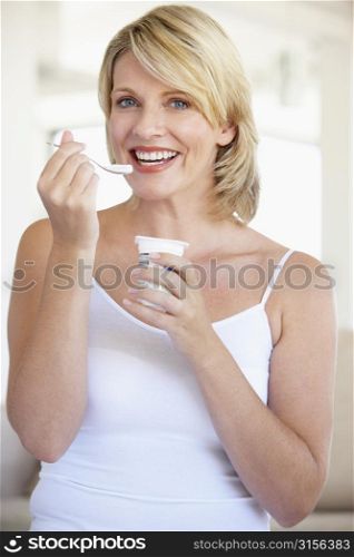 Mid Adult Woman Eating Yogurt