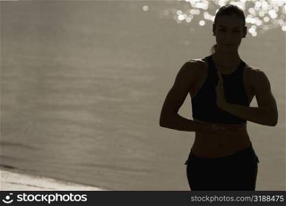 Mid adult woman exercising on the beach