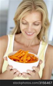 Mid Adult Woman Holding A Bowl Of Carrots
