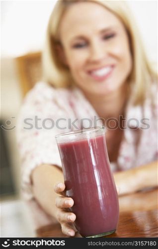 Mid Adult Woman Holding A Fresh Berry Smoothie