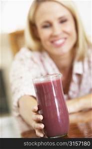 Mid Adult Woman Holding A Fresh Berry Smoothie
