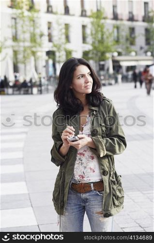 Mid adult woman holding a personal data assistant