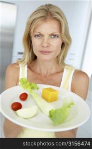 Mid Adult Woman Holding A Plate Of Healthy Food