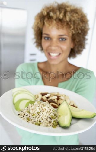 Mid Adult Woman Holding A Plate With Healthy Food