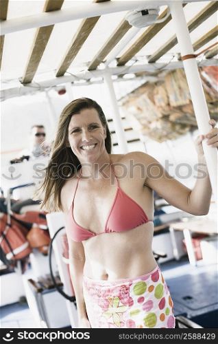 Mid adult woman holding a pole and smiling