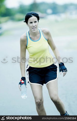 Mid adult woman holding a water bottle
