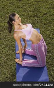 Mid adult woman in a yoga position