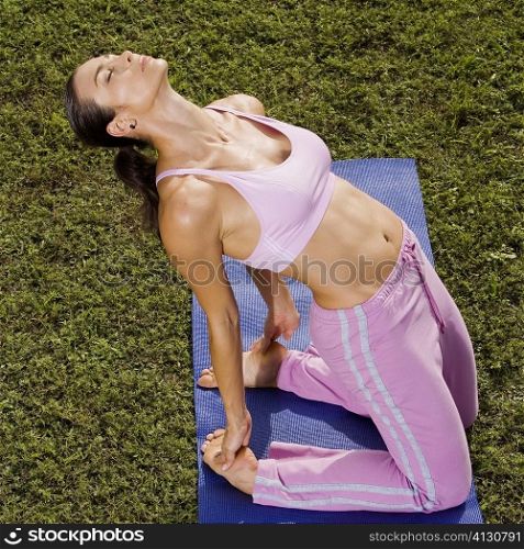 Mid adult woman in a yoga position