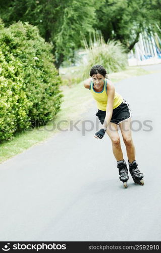 Mid adult woman inline skating