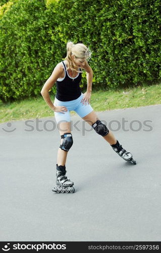 Mid adult woman inline skating