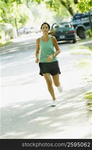 Mid adult woman jogging on the road