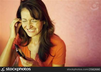 Mid adult woman listening to an MP3 Player