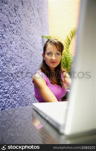 Mid adult woman looking at a laptop