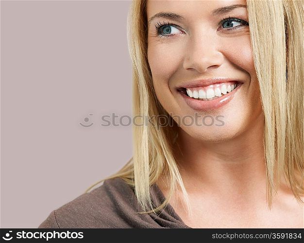 Mid adult woman looking away and smiling close-up