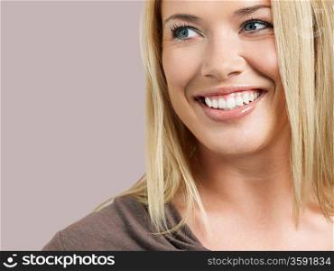 Mid adult woman looking away and smiling close-up