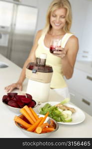 Mid Adult Woman Making Fresh Vegetable Juice