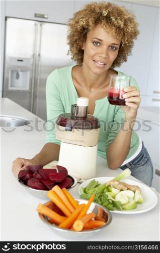 Mid Adult Woman Making Fresh Vegetable Juice