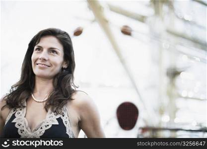 Mid adult woman on a sailing ship and smiling