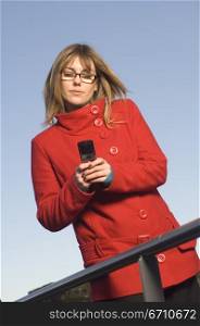 Mid adult woman operating a mobile phone