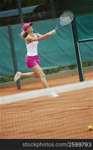 Mid adult woman playing tennis