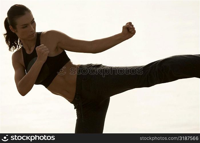 Mid adult woman practicing martial arts