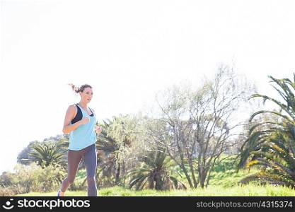 Mid adult woman running in park