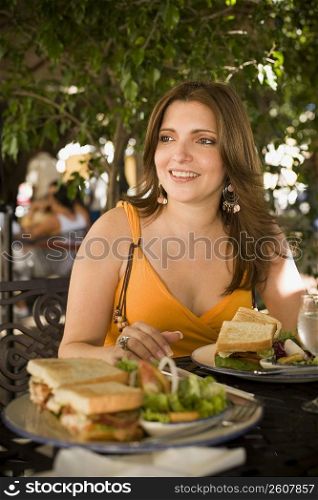 Mid adult woman sitting in a restaurant and smiling, Santo Domingo, Dominican Republic