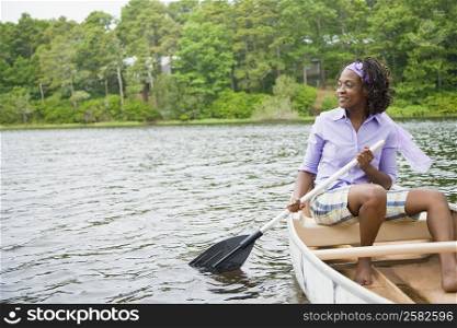 Mid adult woman sitting on a boat and smiling