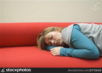 Mid adult woman sleeping on a couch