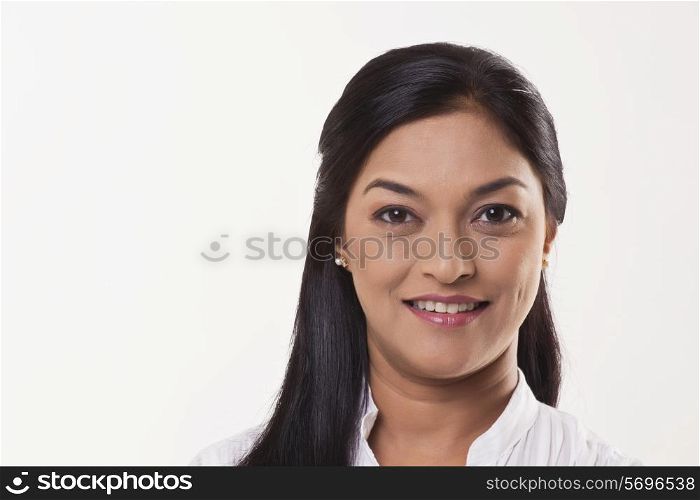 Mid adult woman smiling over white background