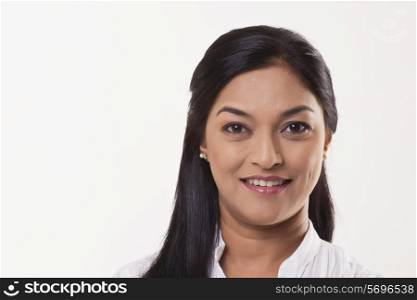 Mid adult woman smiling over white background