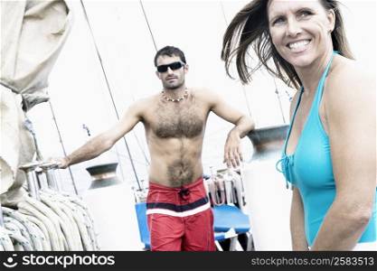 Mid adult woman smiling with a mid adult man standing behind her