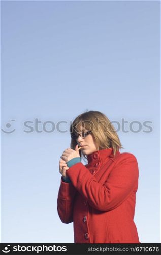 Mid adult woman smoking a cigarette