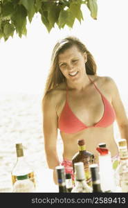 Mid adult woman standing on the beach and smiling