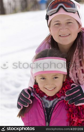 Mid adult woman standing with her daughter