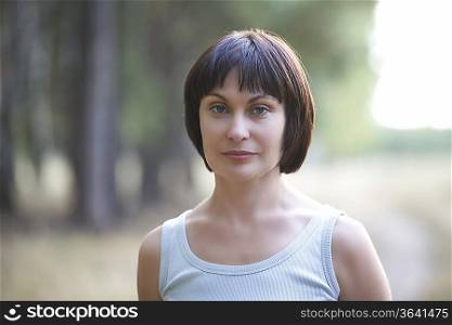 Mid adult woman stares directly at camera portrait