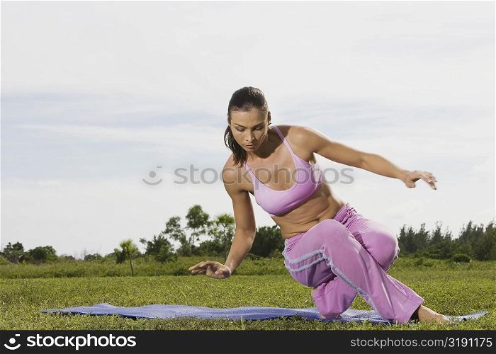 Mid adult woman stretching on an exercise mat