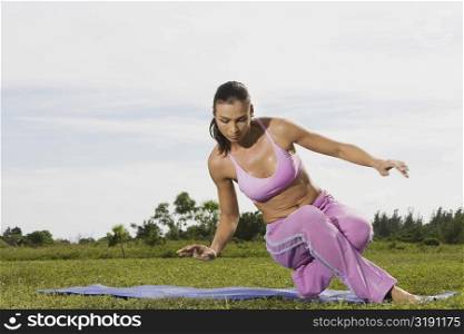 Mid adult woman stretching on an exercise mat