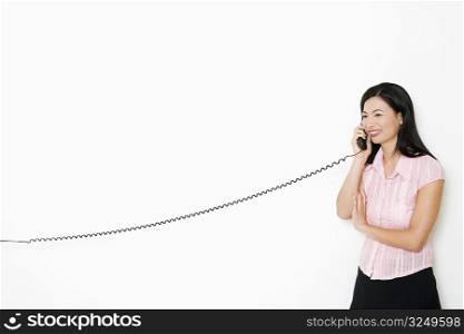 Mid adult woman talking on the telephone