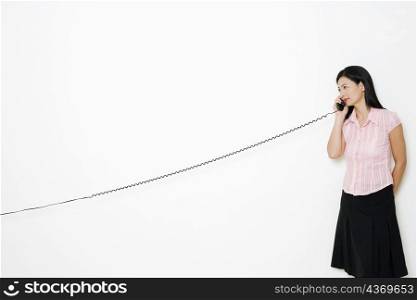 Mid adult woman talking on the telephone
