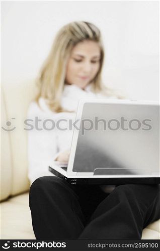 Mid adult woman using a laptop